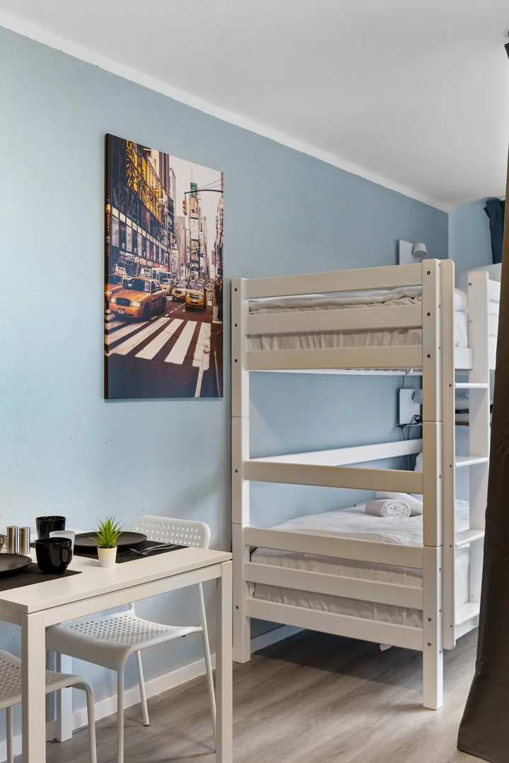 Student room in with study area and shared facilities
