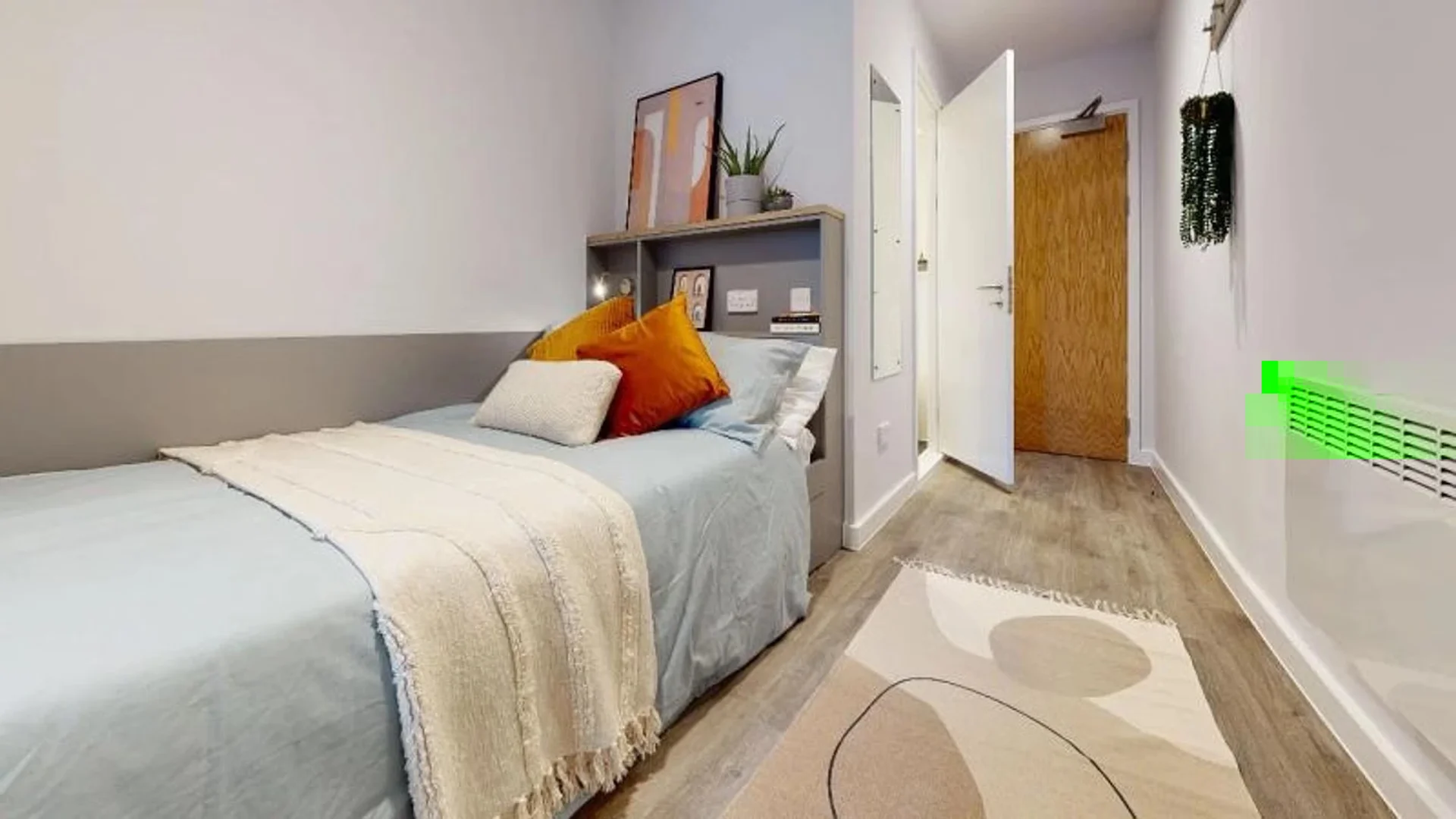 Student room in with study area and shared facilities