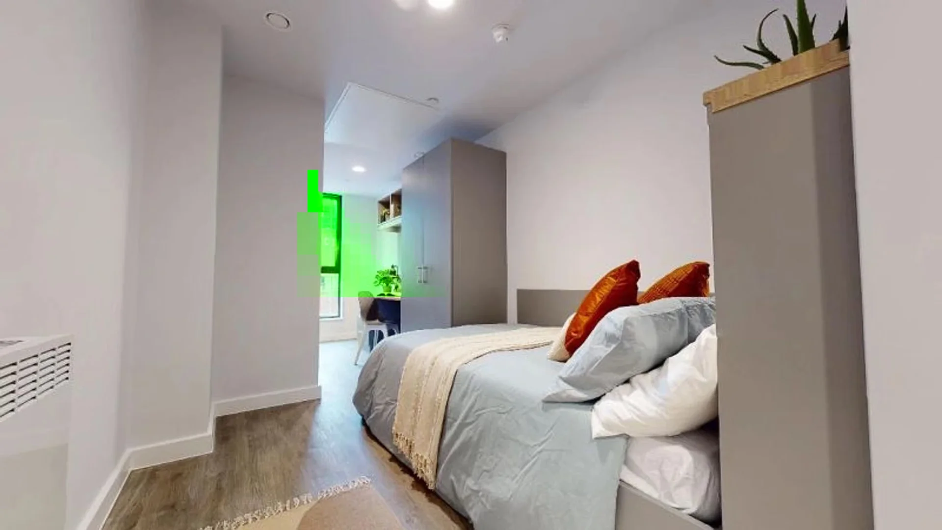 Student room in with study area and shared facilities