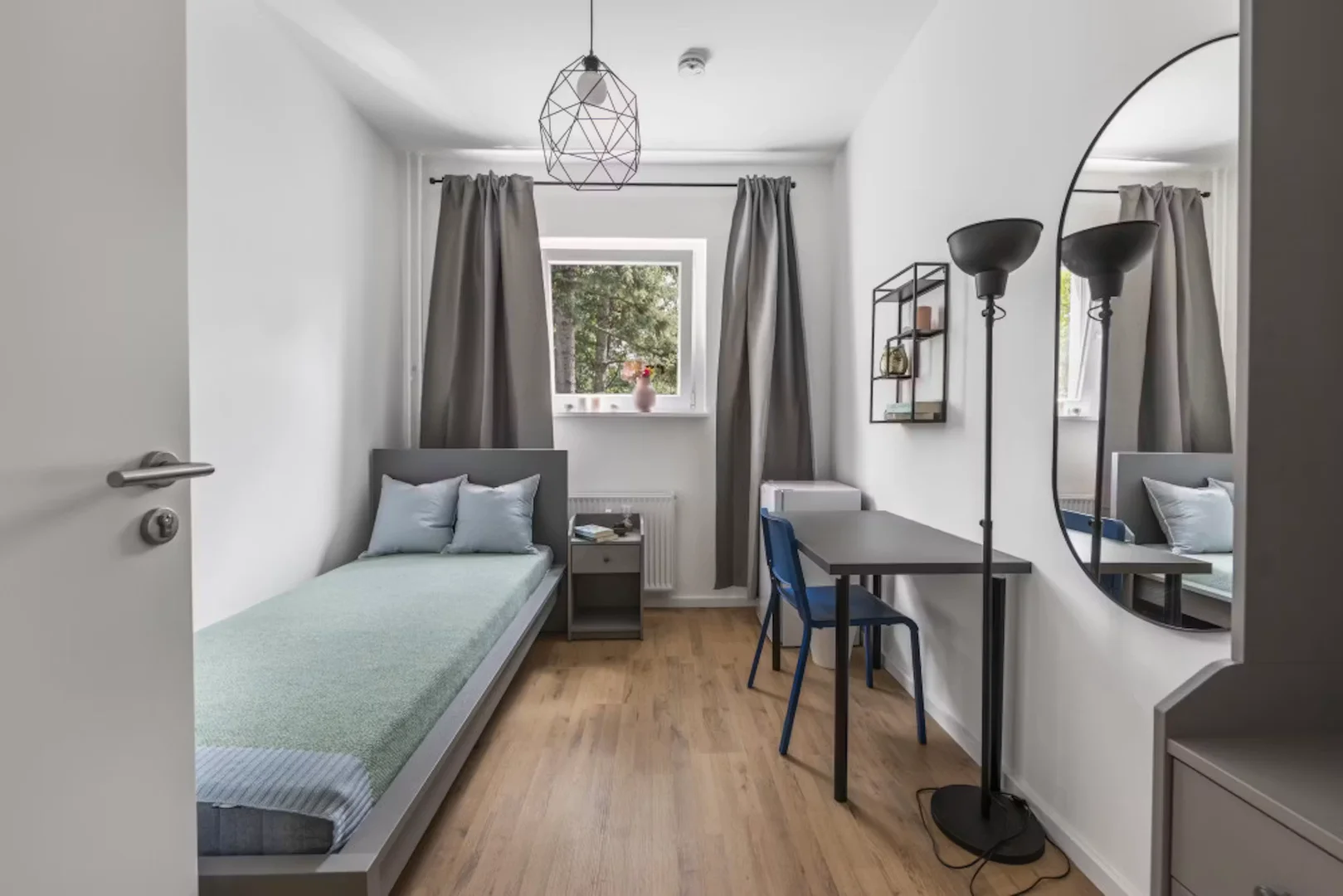 Student room in with study area and shared facilities
