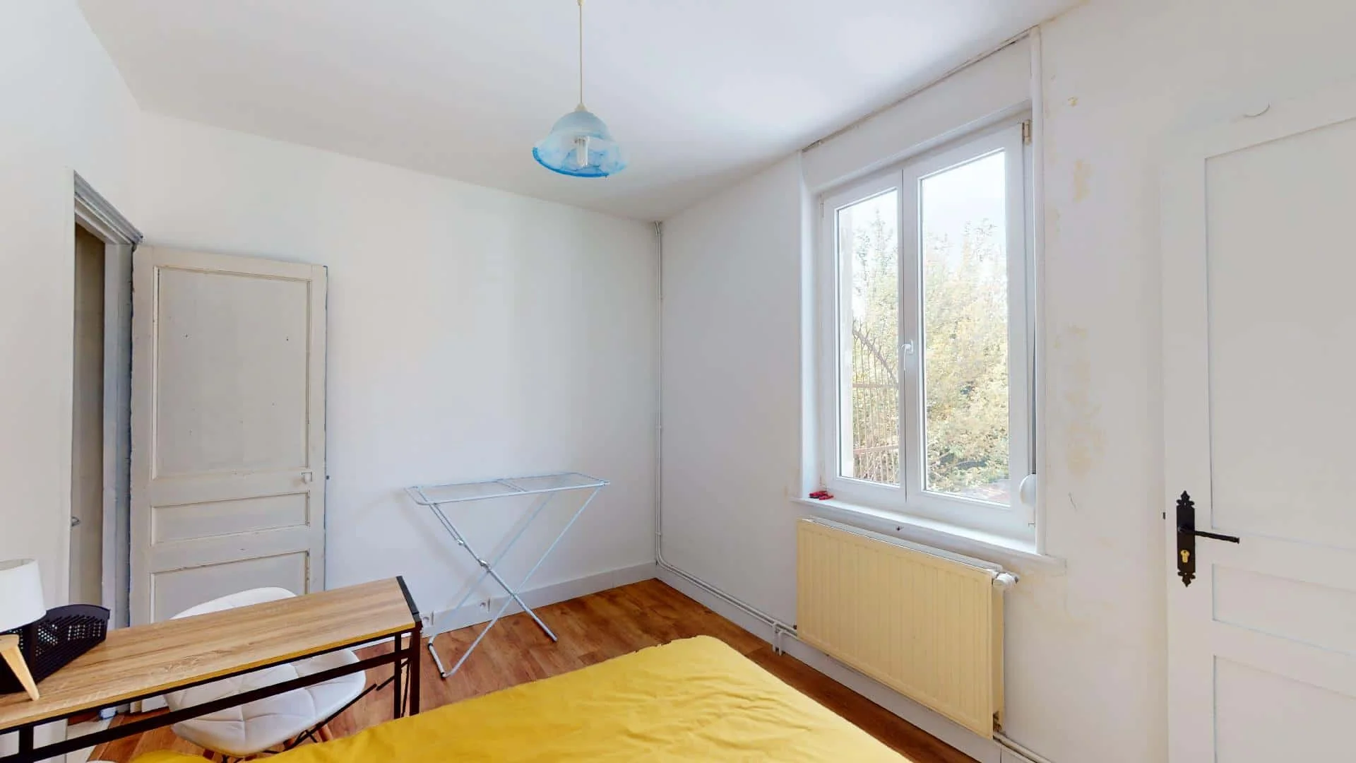 Student room in with study area and shared facilities