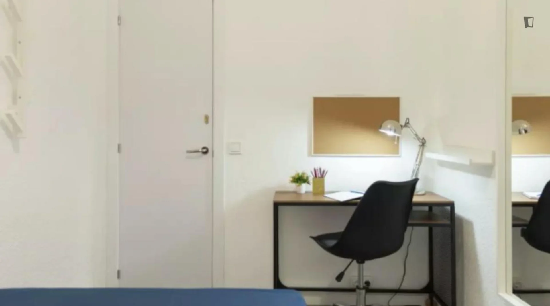 Student room in with study area and shared facilities