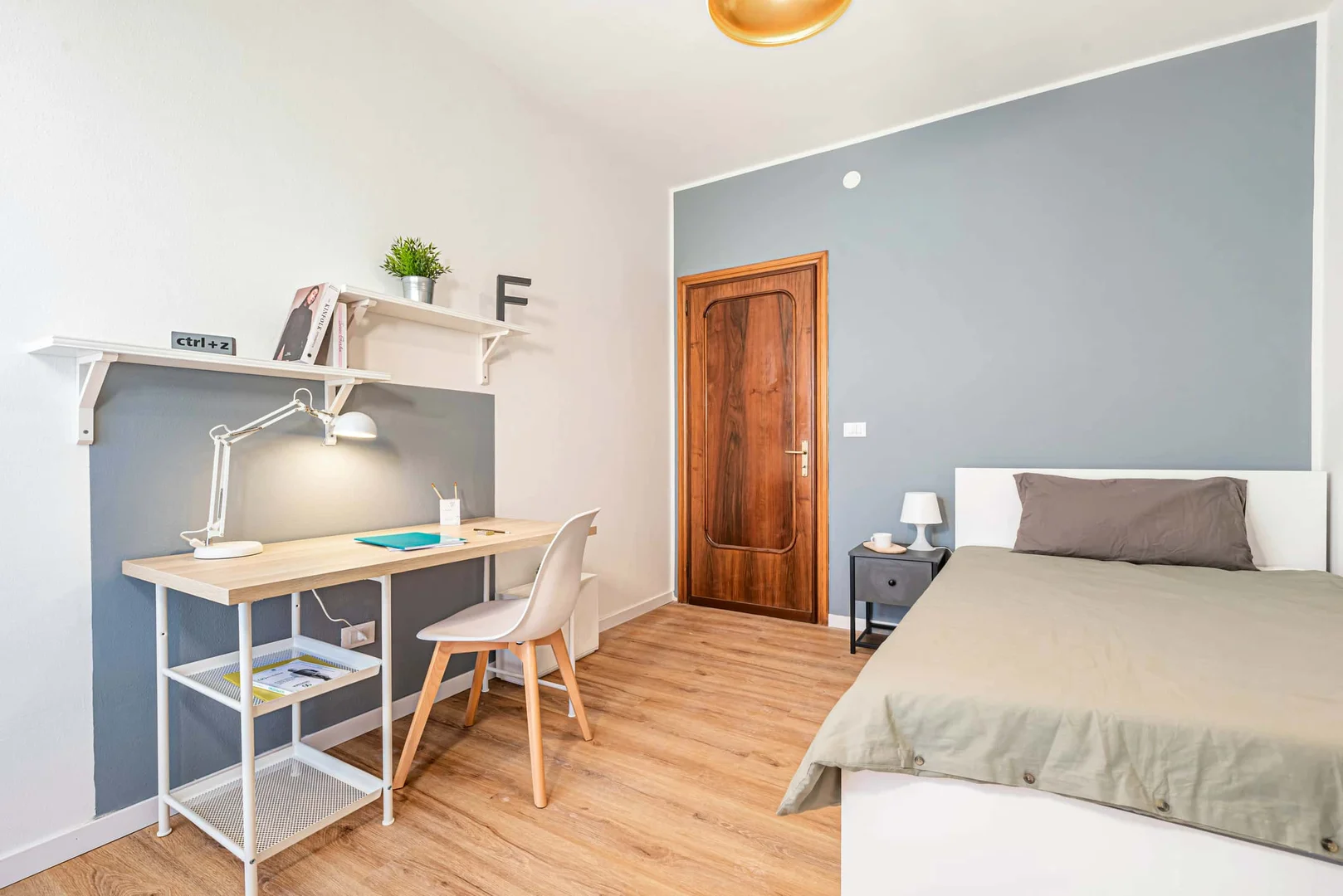 Student room in with study area and shared facilities