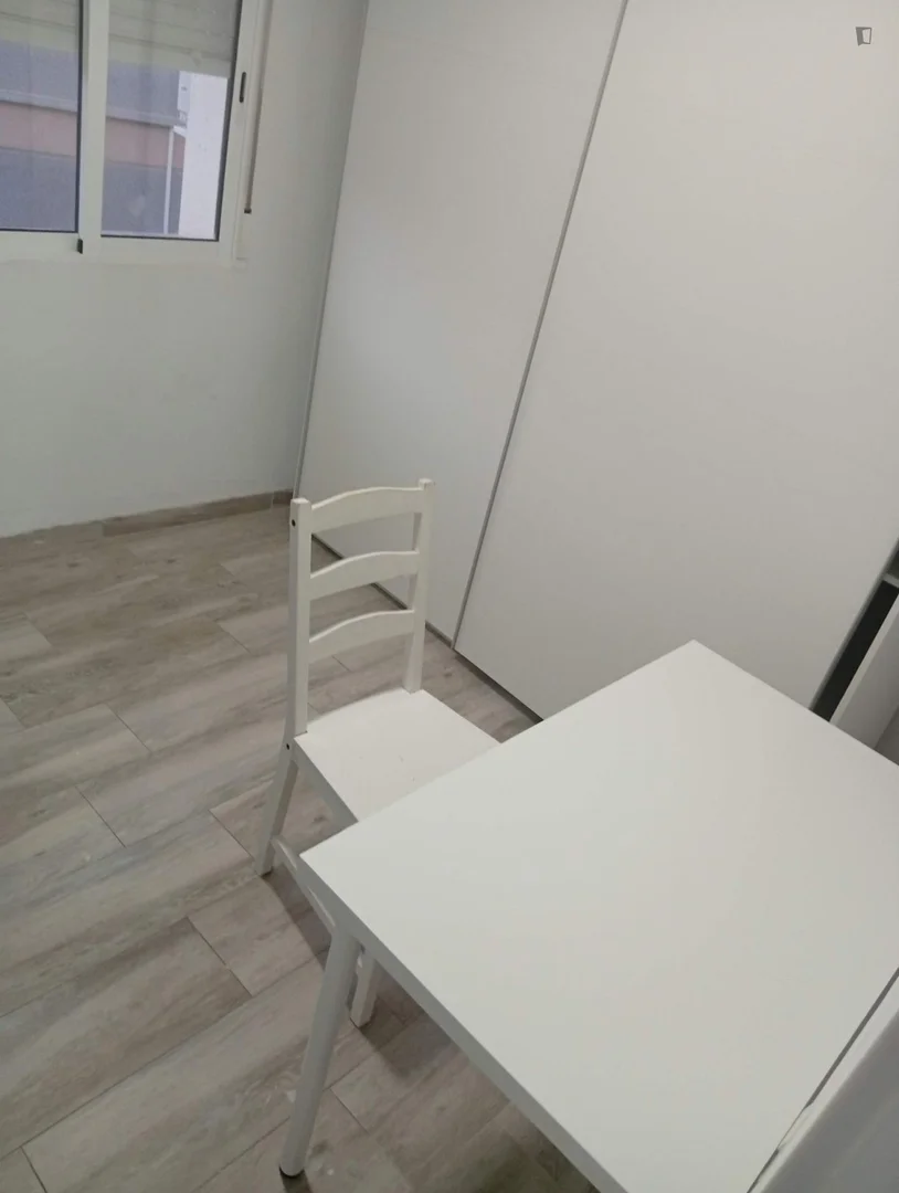 Student room in with study area and shared facilities