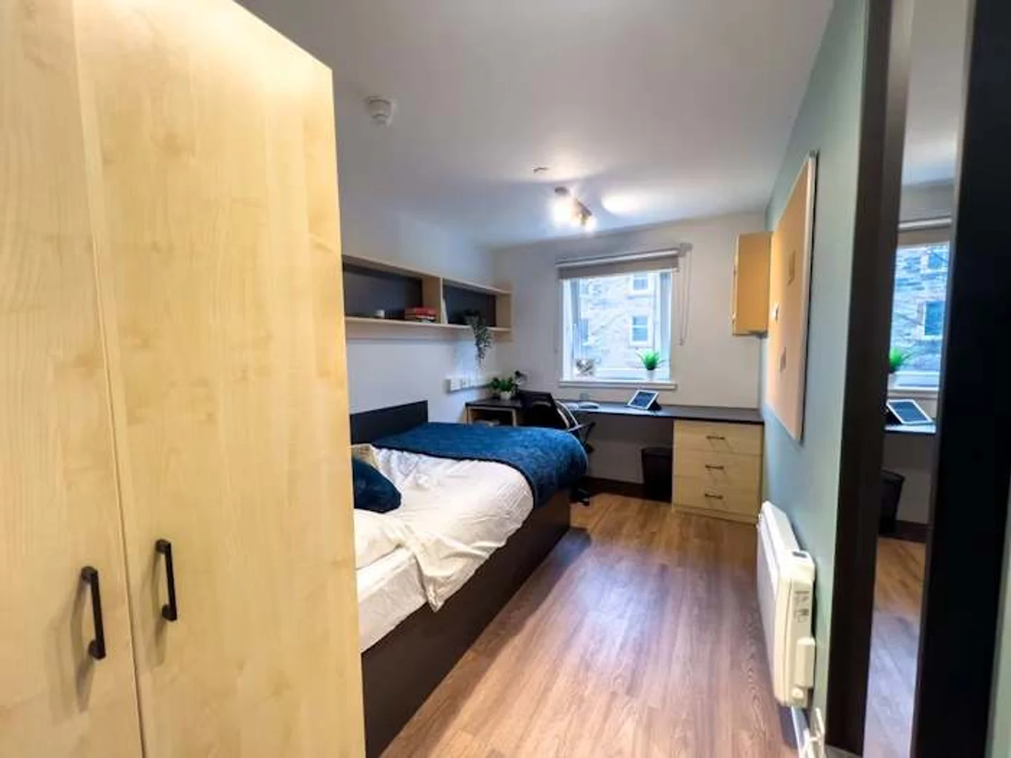 Student room in with study area and shared facilities