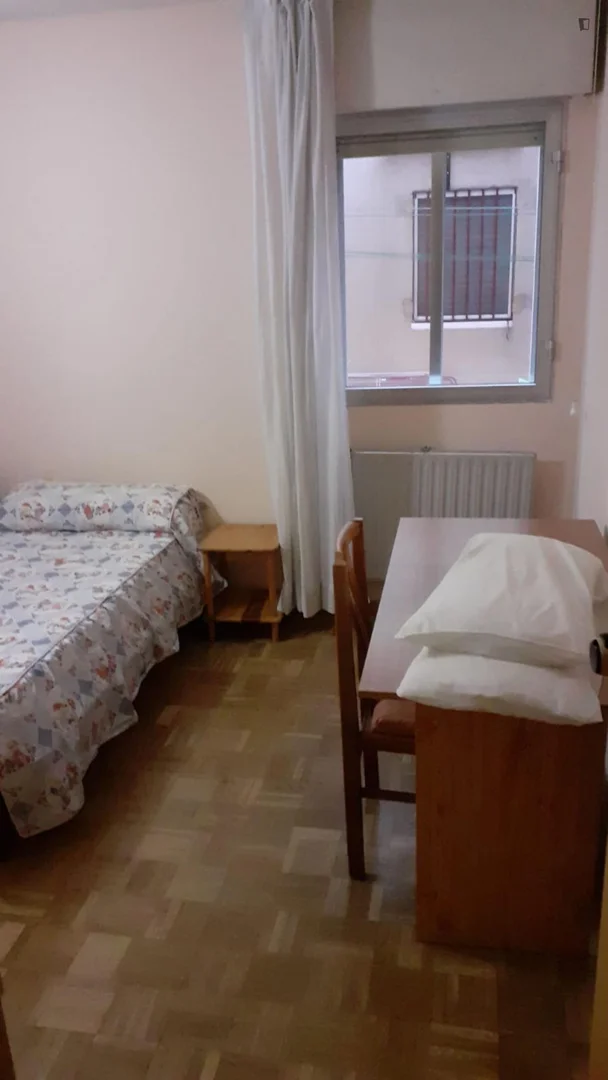 Student room in with study area and shared facilities