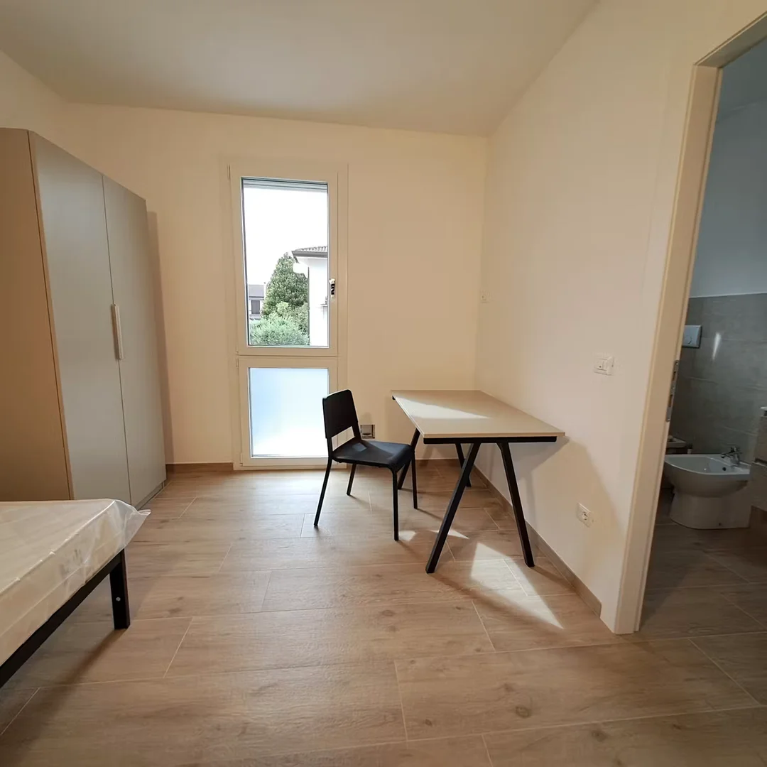 Student room in with study area and shared facilities