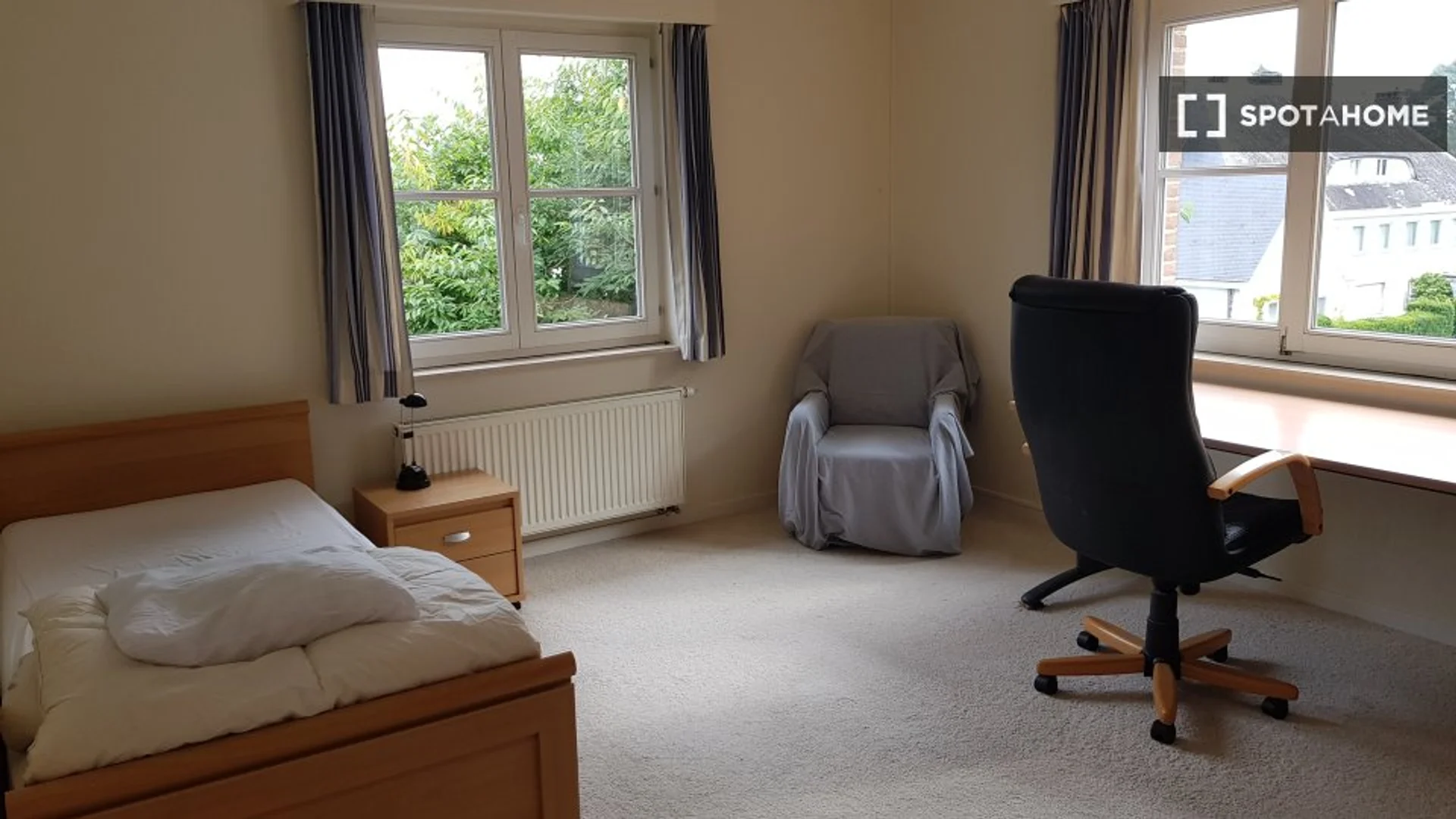 Student room in with study area and shared facilities