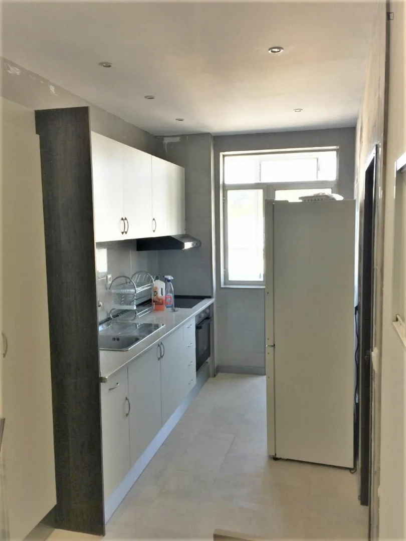 Student room in with study area and shared facilities