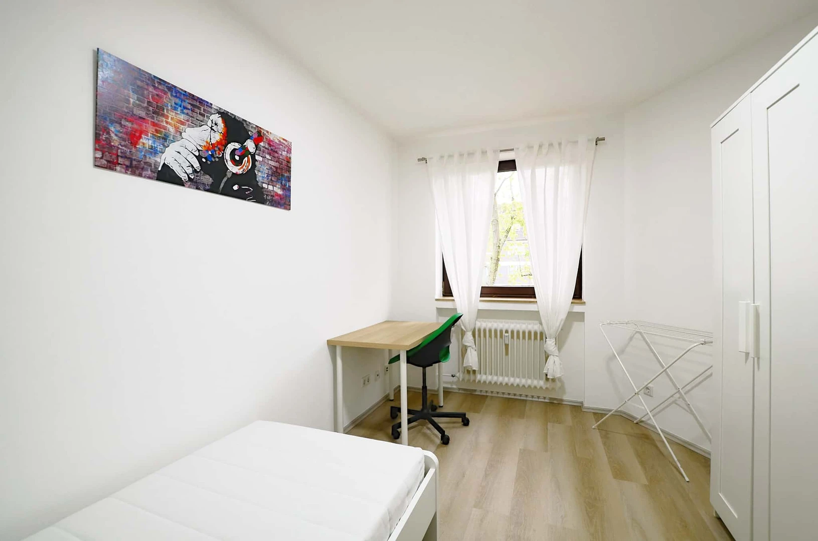 Student room in with study area and shared facilities