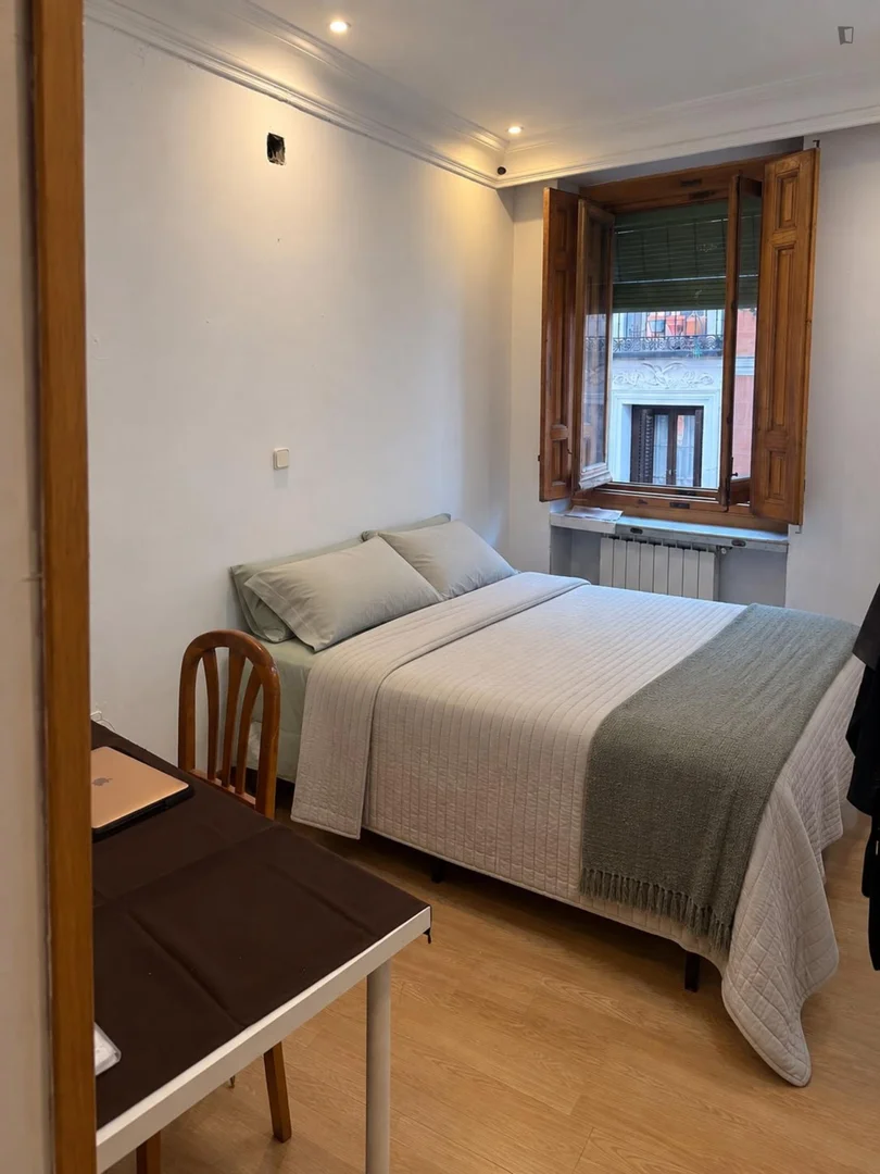 Student room in with study area and shared facilities