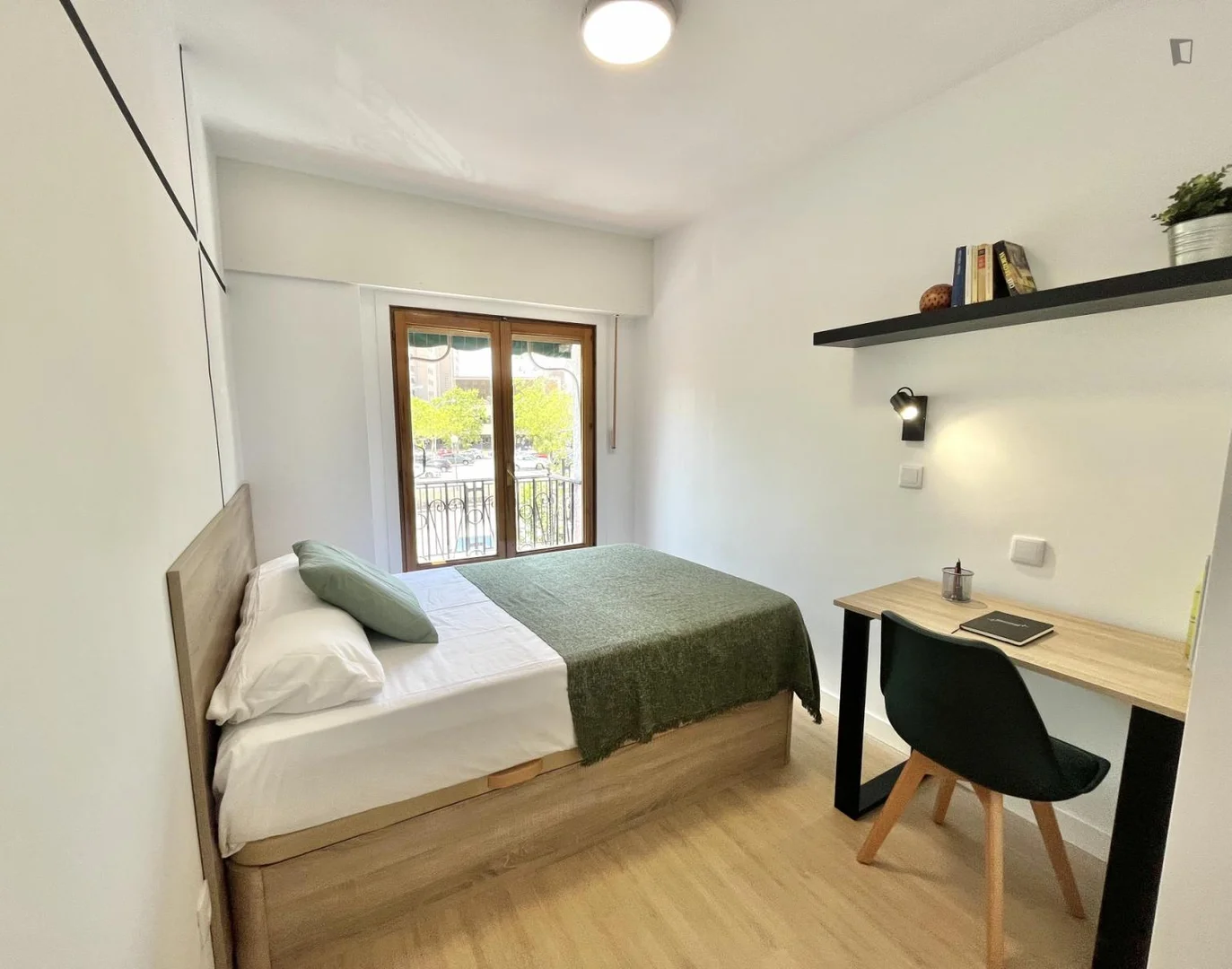 Student room in with study area and shared facilities