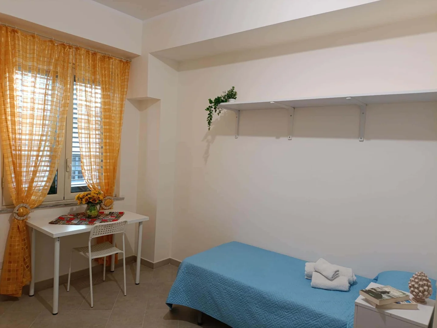 Student room in with study area and shared facilities