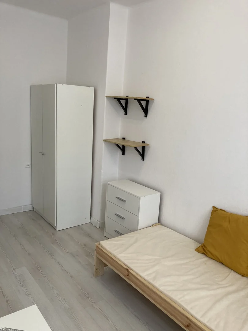 Quarto de estudante luminoso e arejado com acesso fácil à universidade em