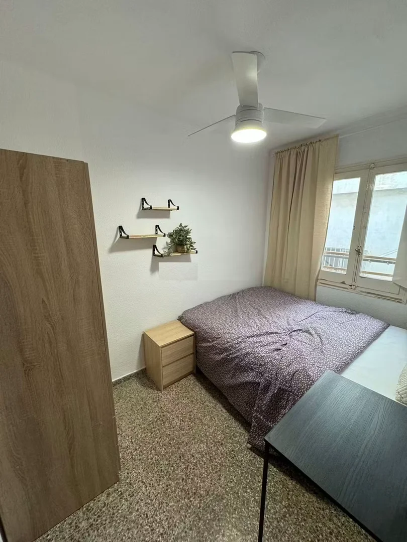 Student room in with study area and shared facilities